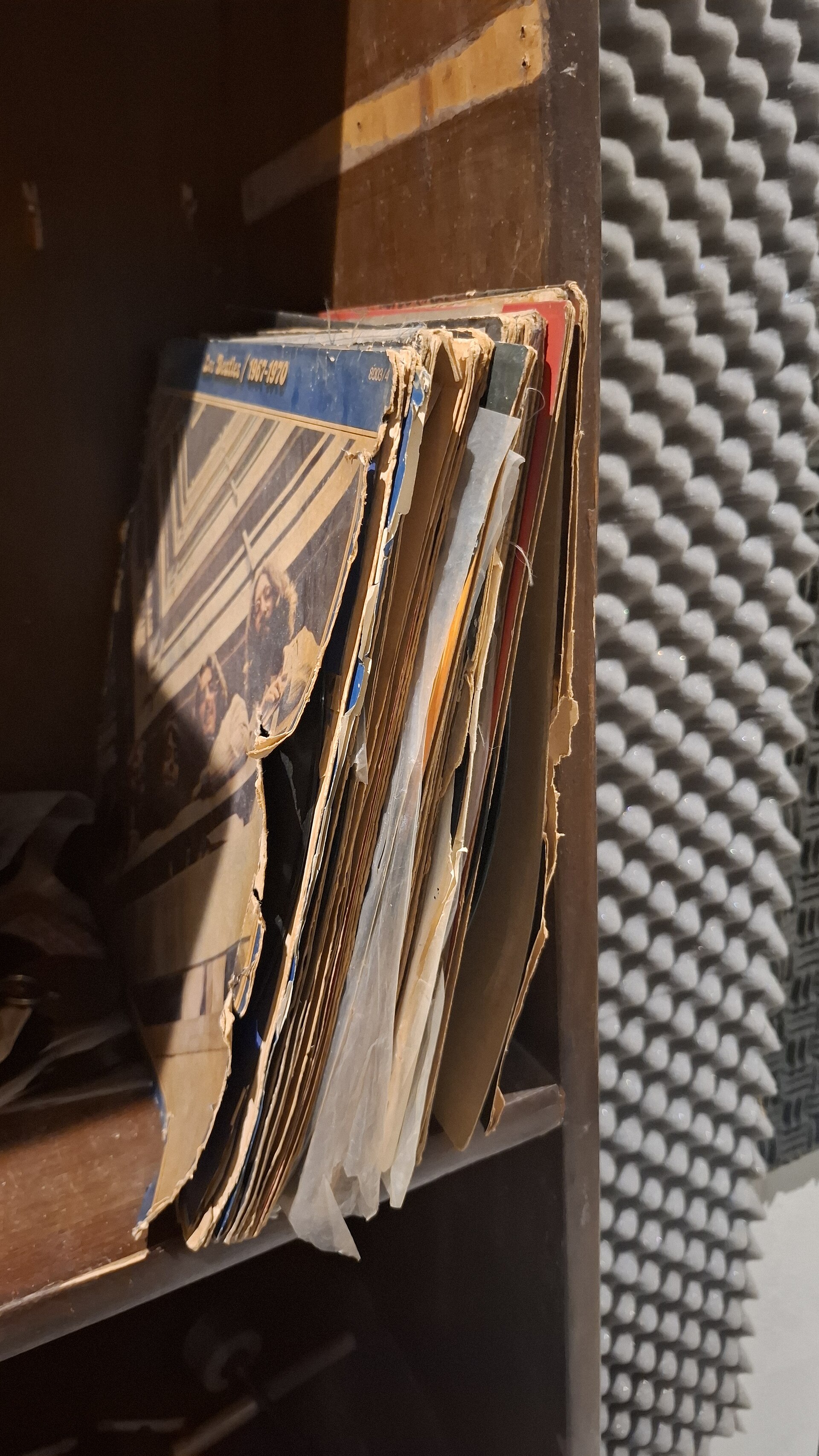A record standing upright, with obvious wear on the sleeve edges
