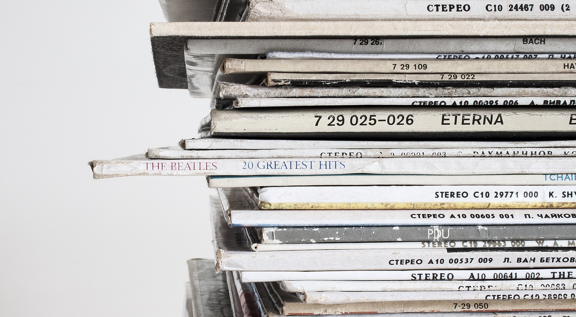 A stack of records lying flat, which is the wrong way to store them